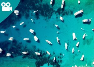 Boats moored in a blue sea, seen from above