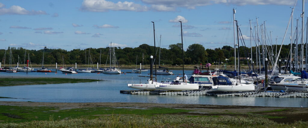 Boats moored at pontoons in a river estuary