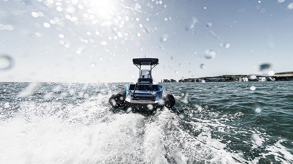 Landscape photo of electric powerboat on water with wake
