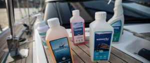 Several Ecoworks cleaning products lined up by a boat