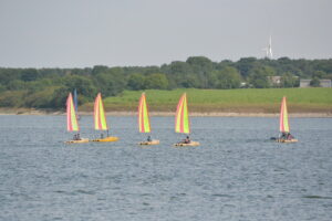 A group of dinghies are racing. 