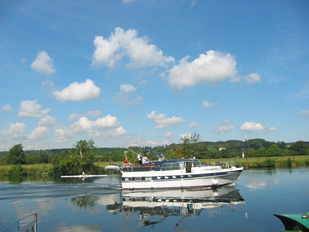 A motor boat cruising along an inland waterway