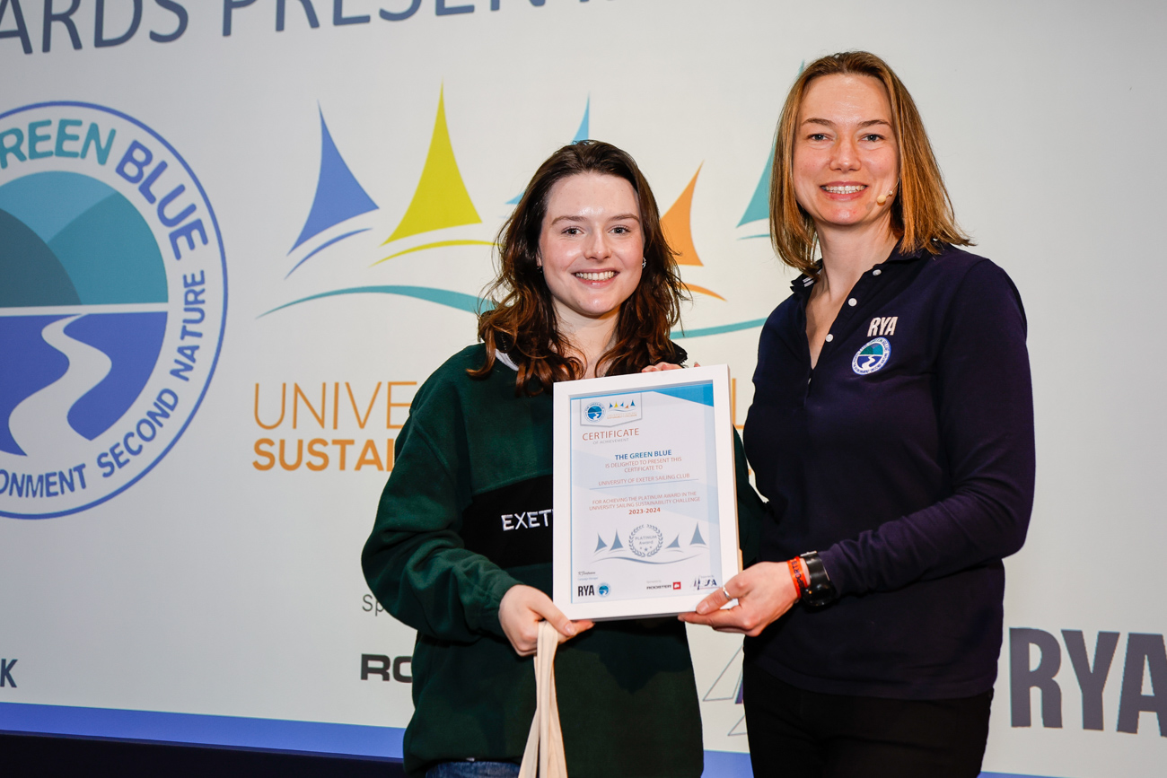 A student collects her club's certificate from Kate Fortnam.