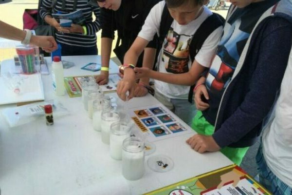 Young people undertaking water quality tests as part of an educational activity called Marine CSI with The Green Blue